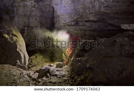 Caver in a dirty cave           