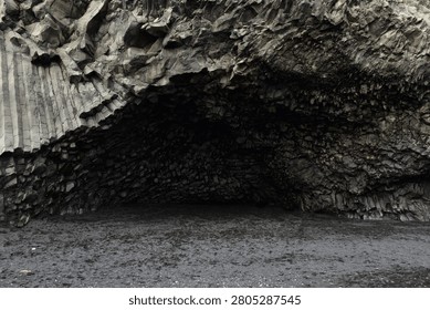 The cavernous opening of Halsanefshellir basalt cave on Reynisfjara beach, Iceland