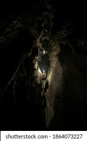 Cavers exploring an uncharted cave