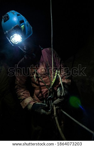 Cavers exploring an uncharted cave