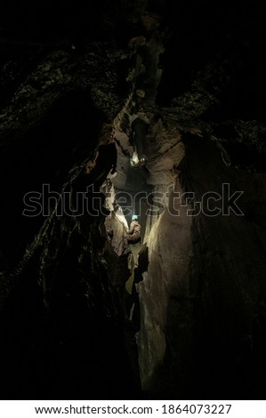 Cavers exploring an uncharted cave