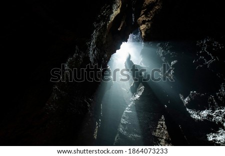 Cavers exploring an uncharted cave