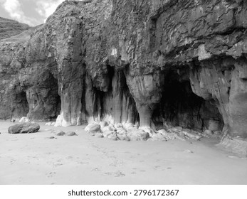 Caves in the limestone cliffs at the sandy beach in Pendine, Carmarthenshire, Wales, UK.