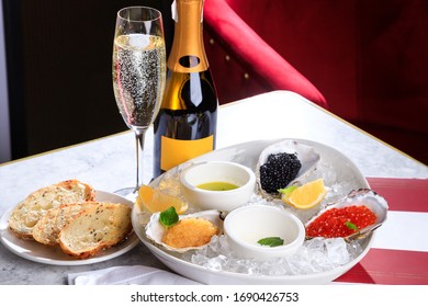 Caviar, Sterlet Caviar, Pike Caviar On White Plate With Ice. Croutons. Bottle And Glass Of Champagne. Sparkling Wine