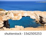 Cavo Greko national park view, Ayia Napa, Cyprus. Rocks, hills, meadows and sea coast. Clear blue water. Holidays in the Mediterranean. Natural stone arch.