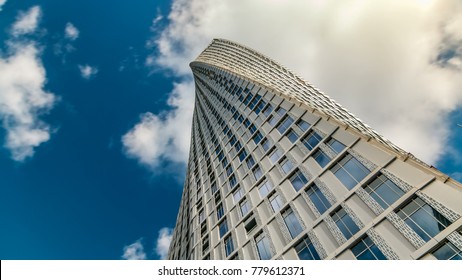 Cayan Tower timelapse (known also as Infinity Tower) in Dubai Marina. Perspective view from bottom to cloudy blue sky, The tower is world's tallest high rise building with a twist of 90 degrees - 306