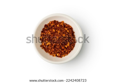 Cayenne pepper powder in white bowl isolated on white background with clipping path.Top view