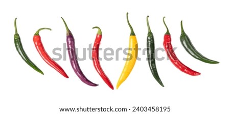 Cayenne peppers, colorful fresh chilies, in a row. Green, red, yellow and purple fruits of moderately hot chili peppers of the type Capsicum annuum. Isolated, from above, on white background. Photo.