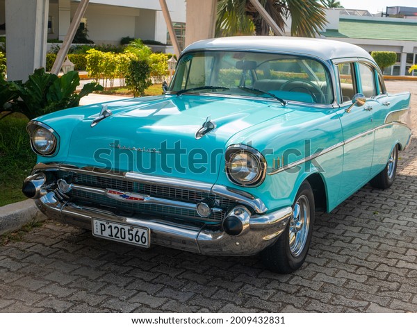 Cayo Coco, Cuba, 16 may 2021:\
Chevrolet Bel Air car is parked outside a Cuban hotel Tryp Cayo\
Coco. The bright blue 1949 car enjoys great attention from\
tourists.