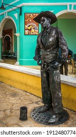Cayo Santa Maria, Cuba, February 2016 - Street mime in black cowboy outfit standing in a corner of La Estrella waiting to entertain visiting tourists