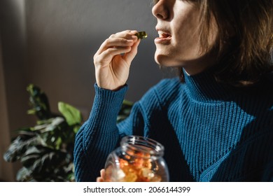 Cbd cannabis gummy - Woman eating edible weed sweet candy leaf for anxiety alternative treatment - Medical marijuana