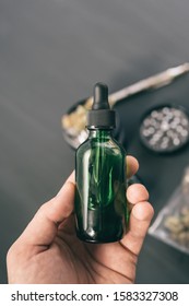 CBD Cannabis OIL Close Up, Product Of Hemp, Medical Marijuana Concept, Hand Holding Bottle Of Cannabis Oil In Pipette, Natural Herb, Vape THC Oil. , Vertical Shot