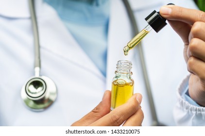 CBD Hemp oil, Doctor holding a bottle of hemp oil, Medical marijuana products including cannabis leaf, cbd and hash oil, alternative medicine