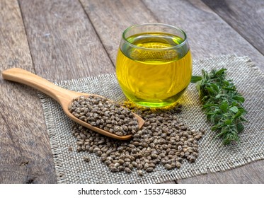 CBD Hemp Oil In A Glass Bottle.Hemp Seeds In A Wooden Spoon  The Hemp Leaf Is Placed On The Table. The Concept Of Cannabis For Medicinal Purposes. Hemp Oil Extraction Components.alternative Medicine.