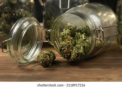 CBD Hemp Weed Buds Stored In A Glass Jar Shrouded With A Smoke Cloud. Medical Cannabis.