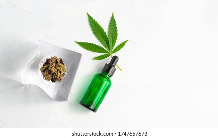 CBD Skin Cream Made From Cannabis Extract For An All Natural Skincare Treatment. Overhead Photography Flat Lay With Cannabis Leaf And CBD Oil.