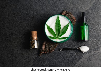 CBD Skin Cream Made From Cannabis Extract For An All Natural Skincare Treatment. Overhead Photography Flat Lay With Cannabis Leaf And CBD Oil.