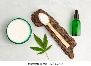 CBD Skin Cream Made From Cannabis Extract For An All Natural Skincare Treatment. Overhead Photography Flat Lay With Cannabis Leaf And CBD Oil.
