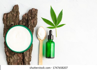 CBD Skin Cream Made From Cannabis Extract For An All Natural Skincare Treatment. Overhead Photography Flat Lay With Cannabis Leaf And CBD Oil.