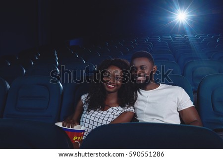 Ccouple of africans watching funny movie.