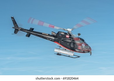 CCOURCHEVEL ALTIPORT - FEBRUARY 25, 2017: Airbus Helicopters H125 - Eurocopter AS350 B3E Ecureuil in flight over Altiport, France. Used to bring people over the Alps Mountains during winter holidays.