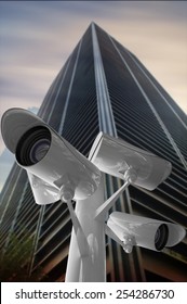 CCTV camera against low angle view of skyscraper