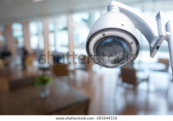 cctv camera with\
blur image of coffee shop