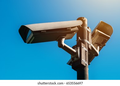 CCTV camera, modern era anti-terrorist electronic surveillance security cameras against blue sky that symbolizes freedom