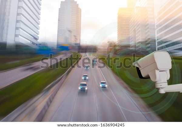A CCTV camera\
new technology 4.0 signal for Checking speed of cars on high way\
and check for safe accident are signal of cars motion detection\
check in city scape\
background.