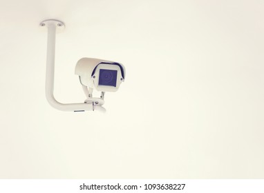 CCTV camera on ceiling background with copy space for text.Can used for security concepts.