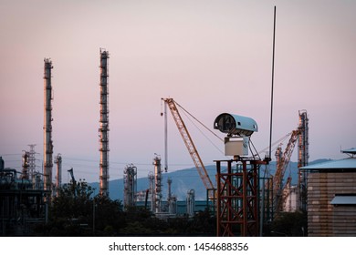 CCTV Camera for security in factory and storage tank at sunset time.
silhouette security camera in petrochemical plant.CCTV camera.
