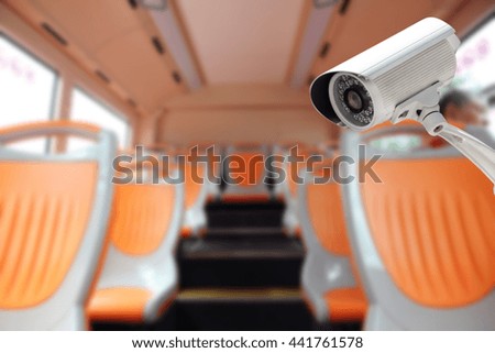 CCTV Camera security operating in a bus, blurred abstract background.