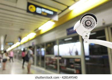 CCTV Camera security operating on subway station platform, blurred abstract background.
