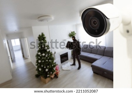 CCTV Camera Showing A Burglar Stealing Things In The House.