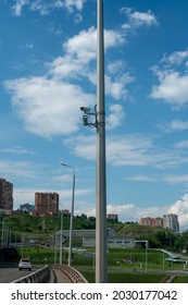 CCTV Cameras On A High Pillar At The Edge Of A Road Bridge. Video Surveillance Of Car Traffic On The Bridge Over The River.