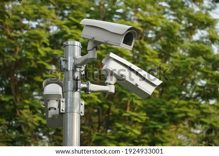 CC.TV. cameras on metal pole in public park for monitor, observe and record evident of incident for investigation and prevent criminal.  Safety, CC.TV. camera concept.                              