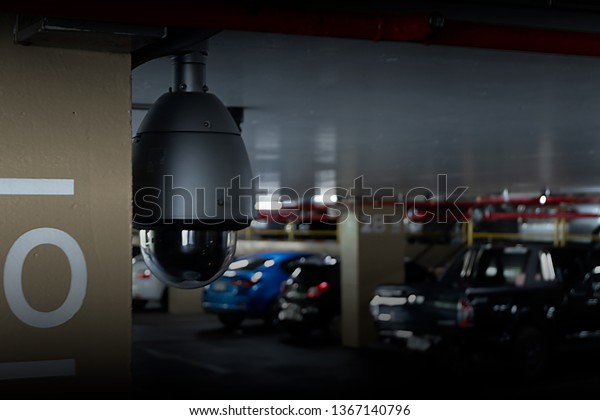 CCTV dome\
camera in car park of shopping\
center