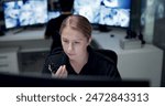 CCTV, radio and security with woman in control room for law enforcement or surveillance. Communication, safety and talking with police officer at police headquarters for crime, inspection or privacy