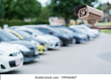 CCTV security camera on blur car parking