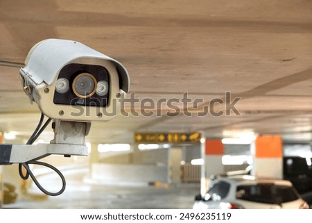 CCTV security camera on blur car parking