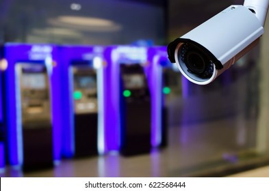 Cctv Security Camera On Blurred Background Of ATM Machine For Withdraw Or Deposit Cash Money, Security Technology Concept