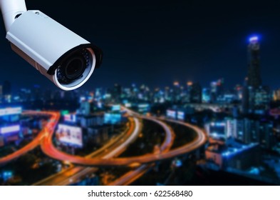 Cctv Security Camera On Blurred Night City In Background, Security Technology Concept