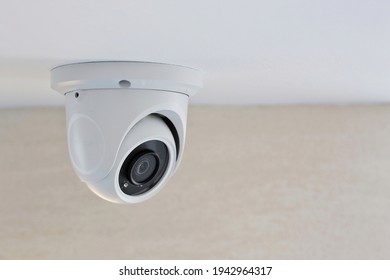CCTV security camera on white ceiling, operating inside the building with copy space. concept of safety control, crime protect.