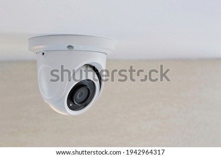 CCTV security camera on white ceiling, operating inside the building with copy space. concept of safety control, crime protect.