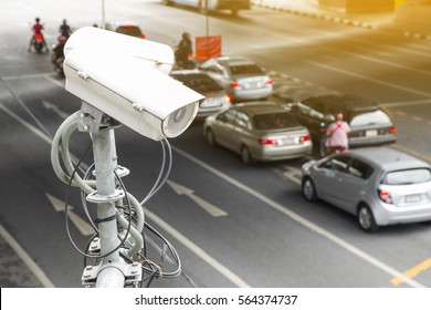 CCTV Security Camera Or Surveillance Operating On Traffic Road And Urban Scene.