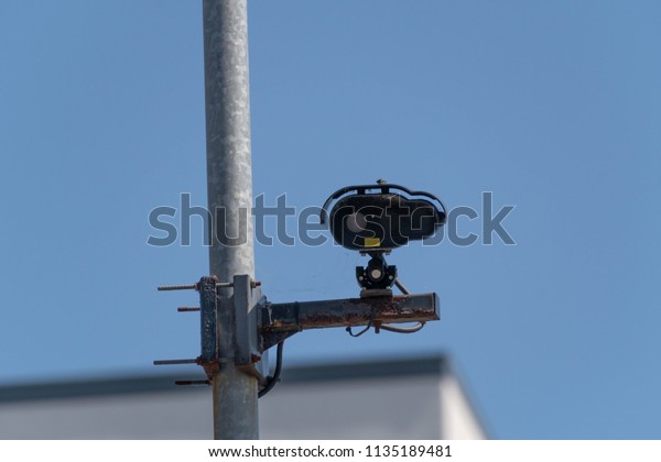A CCTV security\
camera watching a car park