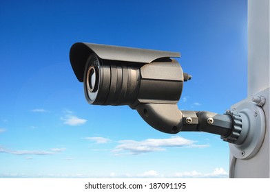 CCTV or surveillance camera on blue sky background