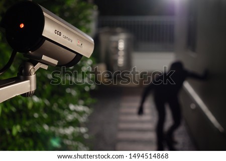 CCTV surveillance camera operate during night capture thief while break into a house