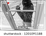 CCTV view of burglar breaking in to home through window with crowbar