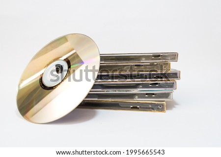 The CD (Compact Disk) and the stack of CD's cover on a white background.